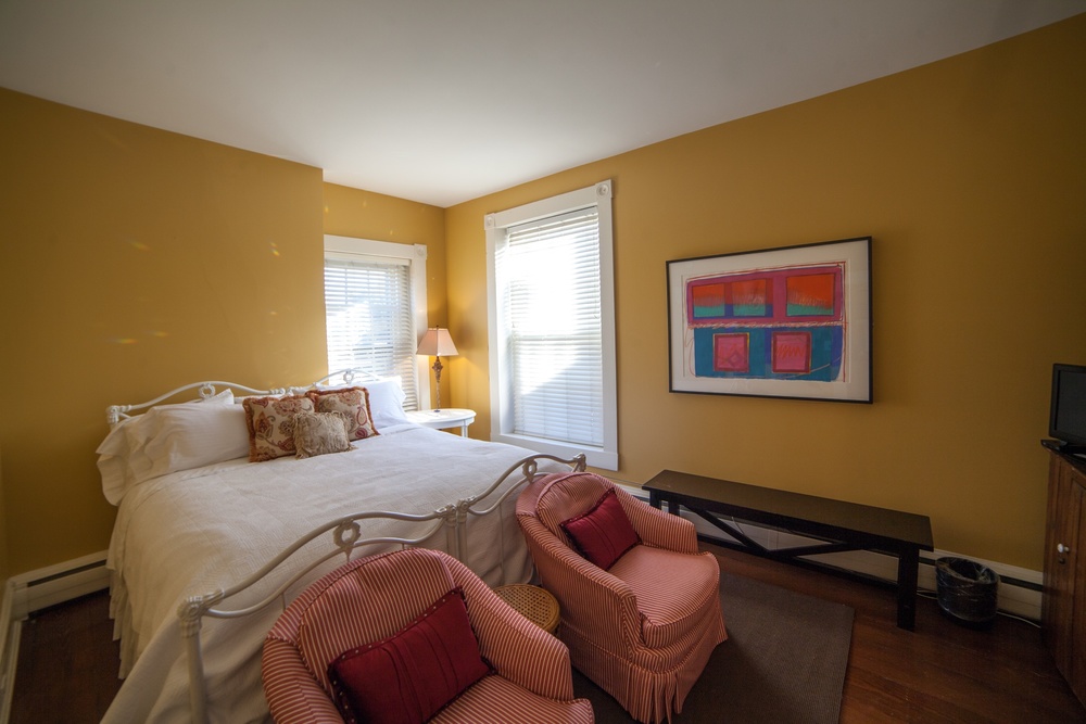 STARKRIMSON PEAR ROOM   Luxurious and plush, this King Suite is complete with cozy club chairs, ample storage space for a longer stay and an extra cozy bed.  This room comes with its own private bath and the best water pressure in the house!  The Starkrimson room is on the second floor and includes complementary breakfast, a television, wi-fi, and large private bath with spacious stall shower.  